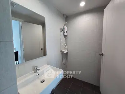 Modern bathroom with sleek fixtures and spacious shower area