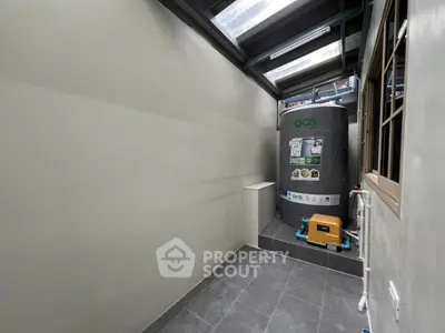 Spacious utility area with water tank and modern flooring
