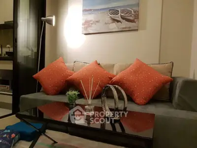 Cozy living room with modern decor and stylish orange cushions.
