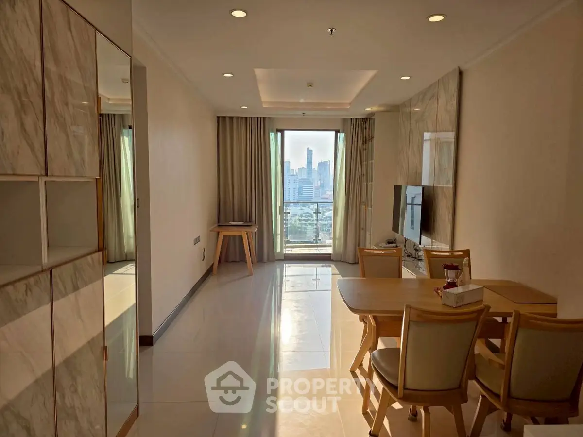 Modern living room with city view, elegant dining set, and sleek TV setup in a high-rise apartment.