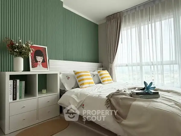 Charming bedroom with modern decor and ample natural light, featuring stylish furniture and cozy ambiance.