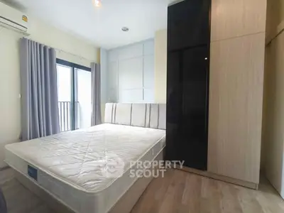 Modern bedroom with large window and sleek wardrobe design