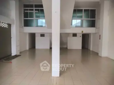 Spacious commercial property with high ceilings and tiled flooring, ideal for retail or office use.