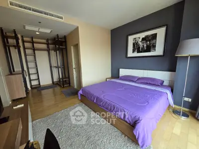 Spacious bedroom with modern decor and ample storage in a stylish apartment.