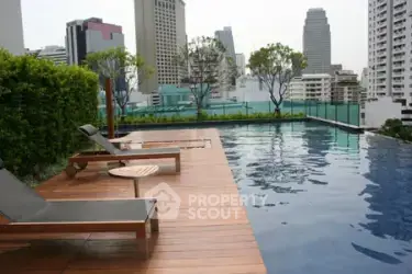Luxurious rooftop pool with city skyline views and modern lounge chairs.