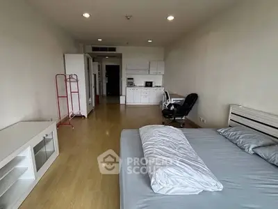 Spacious bedroom with modern furnishings and wooden flooring, ideal for comfortable living.