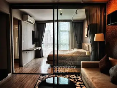 Luxurious modern bedroom with glass partition and city view, featuring elegant decor and ambient lighting.