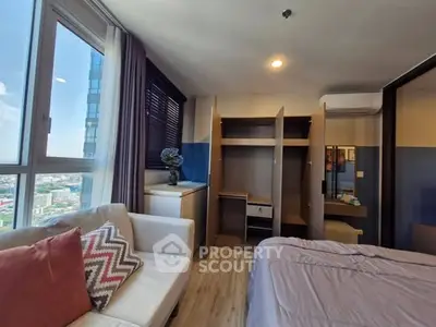 Modern bedroom with city view, cozy sofa, and stylish decor