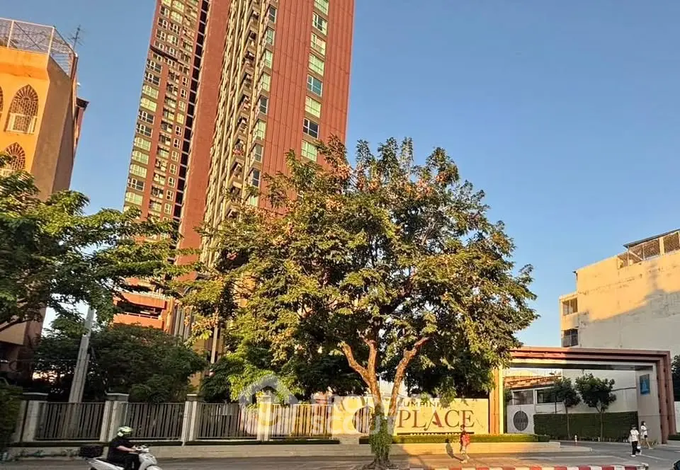 Stunning high-rise building with modern architecture and lush greenery in urban setting.