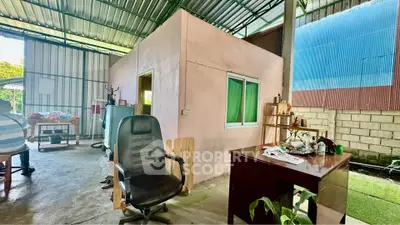 Unique industrial-style workspace with enclosed office and open seating area.