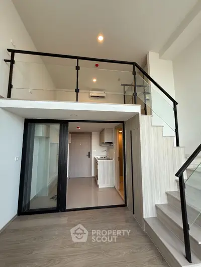 Modern loft-style apartment with mezzanine and sleek kitchen design