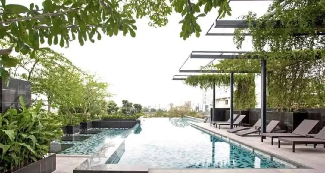 Luxurious rooftop pool with city view and modern lounge chairs