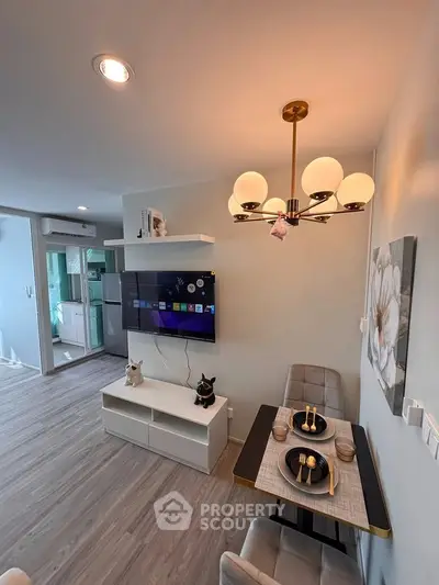 Modern living room with stylish dining area and wall-mounted TV, featuring elegant lighting and contemporary decor.