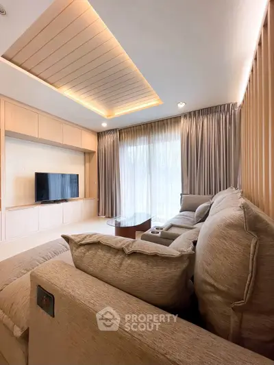 Luxurious living room with modern decor and large windows for natural light.