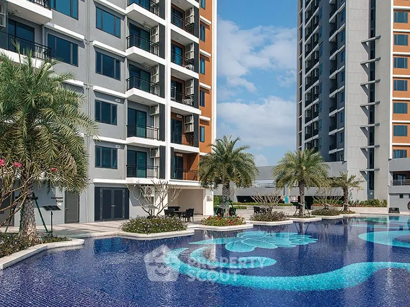 Luxurious apartment complex with stunning pool and palm trees