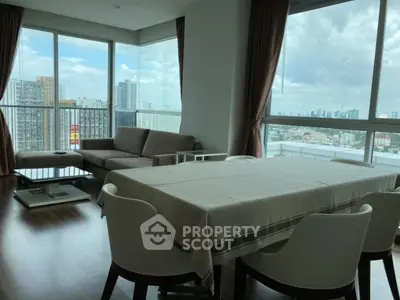 Spacious corner unit living room with panoramic city views and elegant dining area.