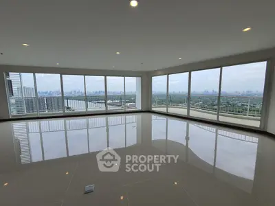 Spacious corner unit with panoramic city and river views, featuring floor-to-ceiling windows and glossy tile flooring.