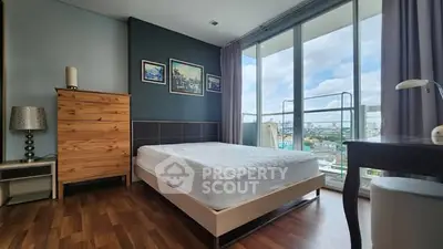 Spacious bedroom with city view and modern decor