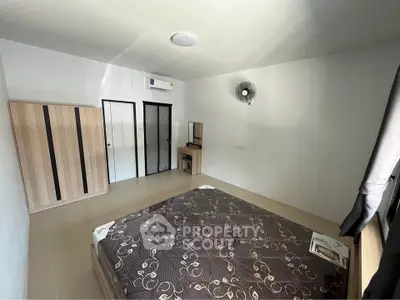 Spacious bedroom with modern furniture and natural light