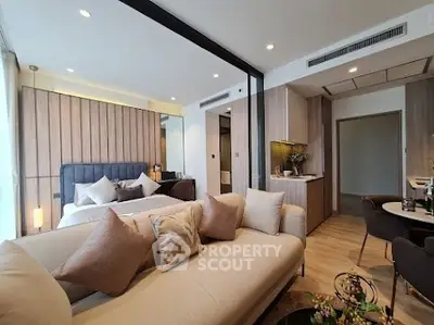 Luxurious open-plan living room and bedroom with modern decor and cozy ambiance.