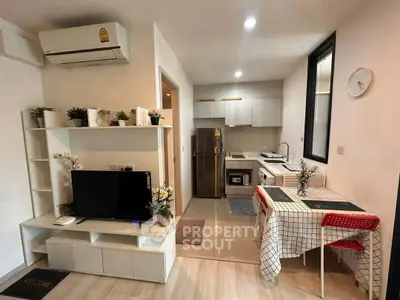 Modern open-plan living room and kitchen with stylish decor and appliances.