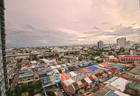 Stunning cityscape view from high-rise apartment showcasing vibrant urban life.