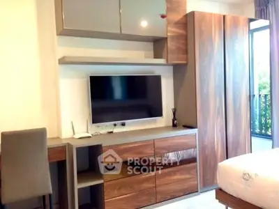 Modern bedroom with sleek wooden furniture and wall-mounted TV