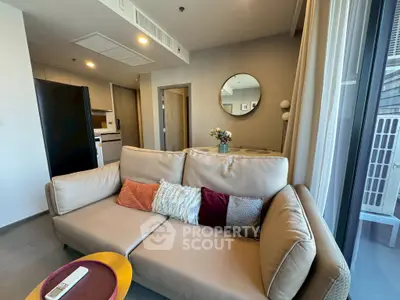 Modern living room with cozy beige sofa and stylish decor in a contemporary apartment.