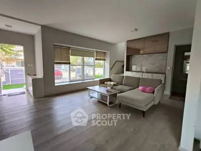 Spacious modern living room with large windows and stylish furniture