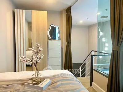 Stylish modern bedroom with elegant decor and unique lighting, perfect for urban living.