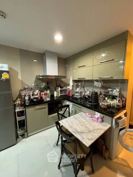 Cozy kitchen with modern appliances and dining area in compact layout