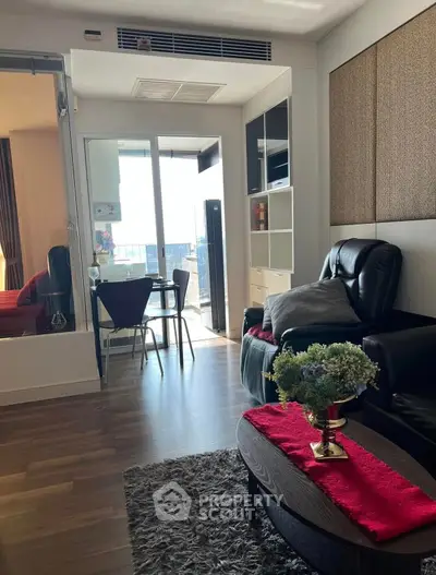 Modern living room with cozy seating and dining area, featuring stylish decor and ample natural light.