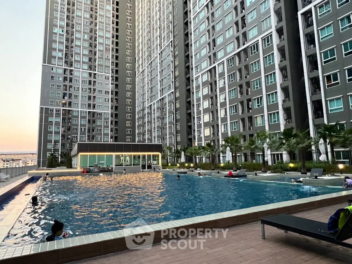 Luxurious high-rise apartment complex with stunning pool and modern amenities.