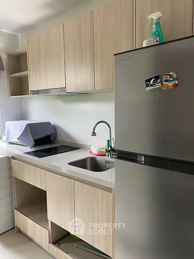 Modern kitchen with sleek cabinetry and stainless steel fridge