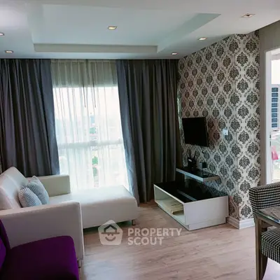 Stylish living room with modern decor and large window offering city views.