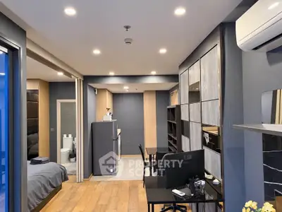 Modern studio apartment with open layout, featuring a cozy bedroom, sleek kitchen, and stylish living area.