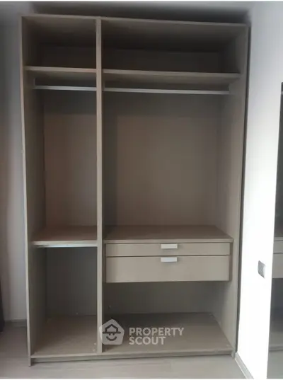 Spacious modern wardrobe with shelves and drawers in a sleek design, perfect for organized storage.