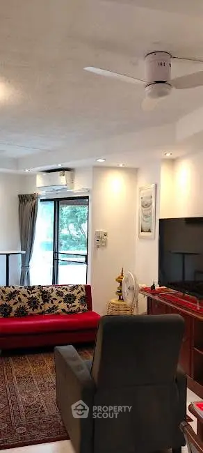 Spacious living room with modern decor and large window view