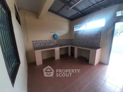 Spacious kitchen with tiled backsplash and open layout, perfect for culinary enthusiasts.