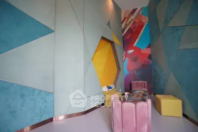 Modern interior with geometric wall design and colorful seating area