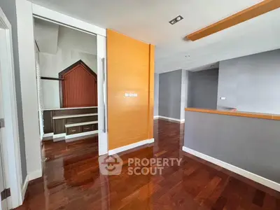 Spacious interior with polished wooden floors and modern design elements.