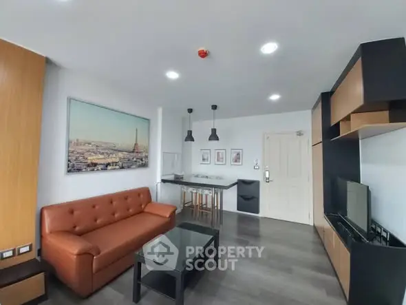 Modern living room with stylish furniture and wall art in a cozy apartment.