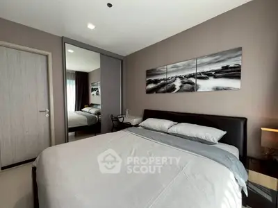 Modern bedroom with stylish decor and comfortable bedding in a contemporary apartment.
