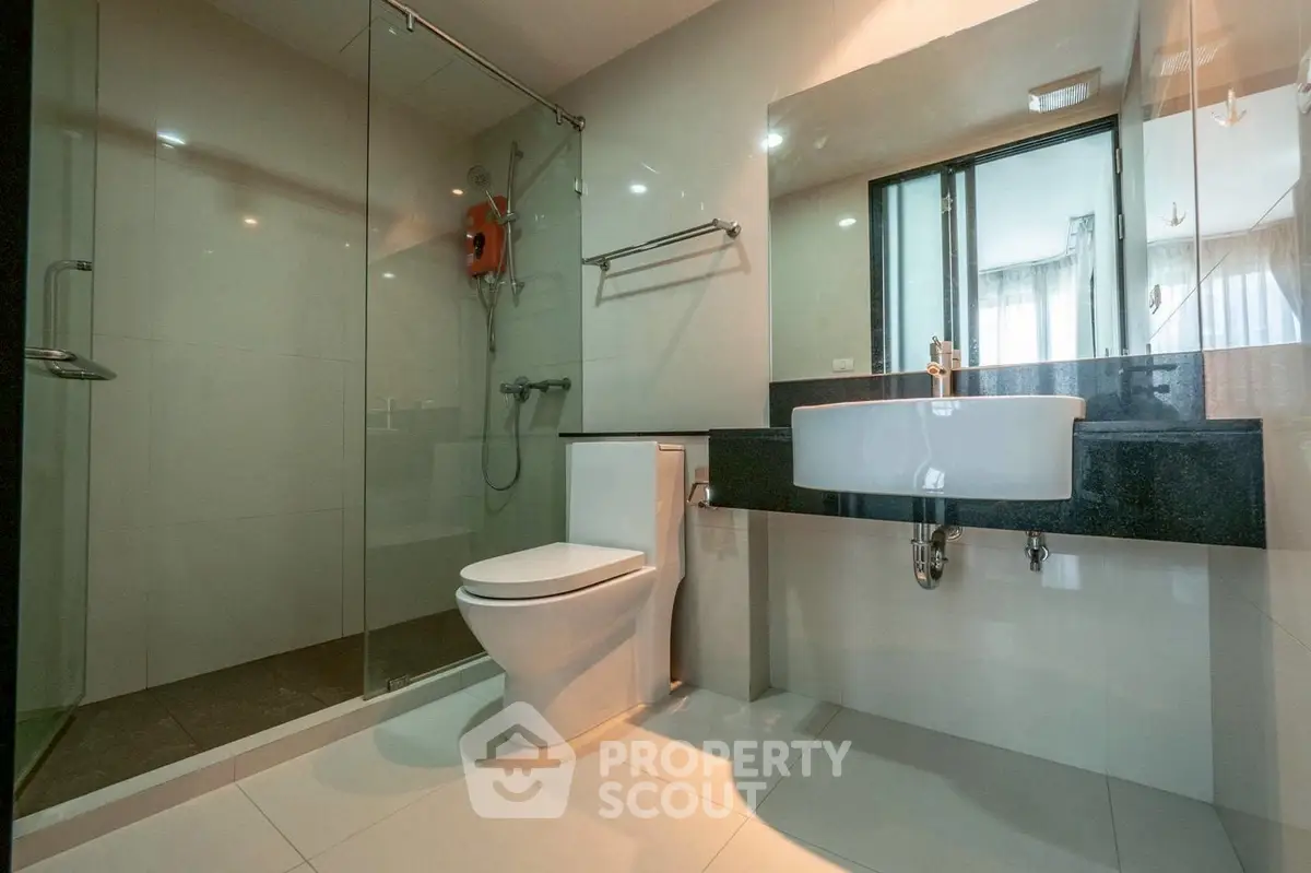 Modern bathroom with glass shower and sleek fixtures