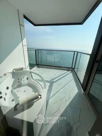 Luxurious balcony with ocean view and private jacuzzi, perfect for relaxation and enjoying the sea breeze.