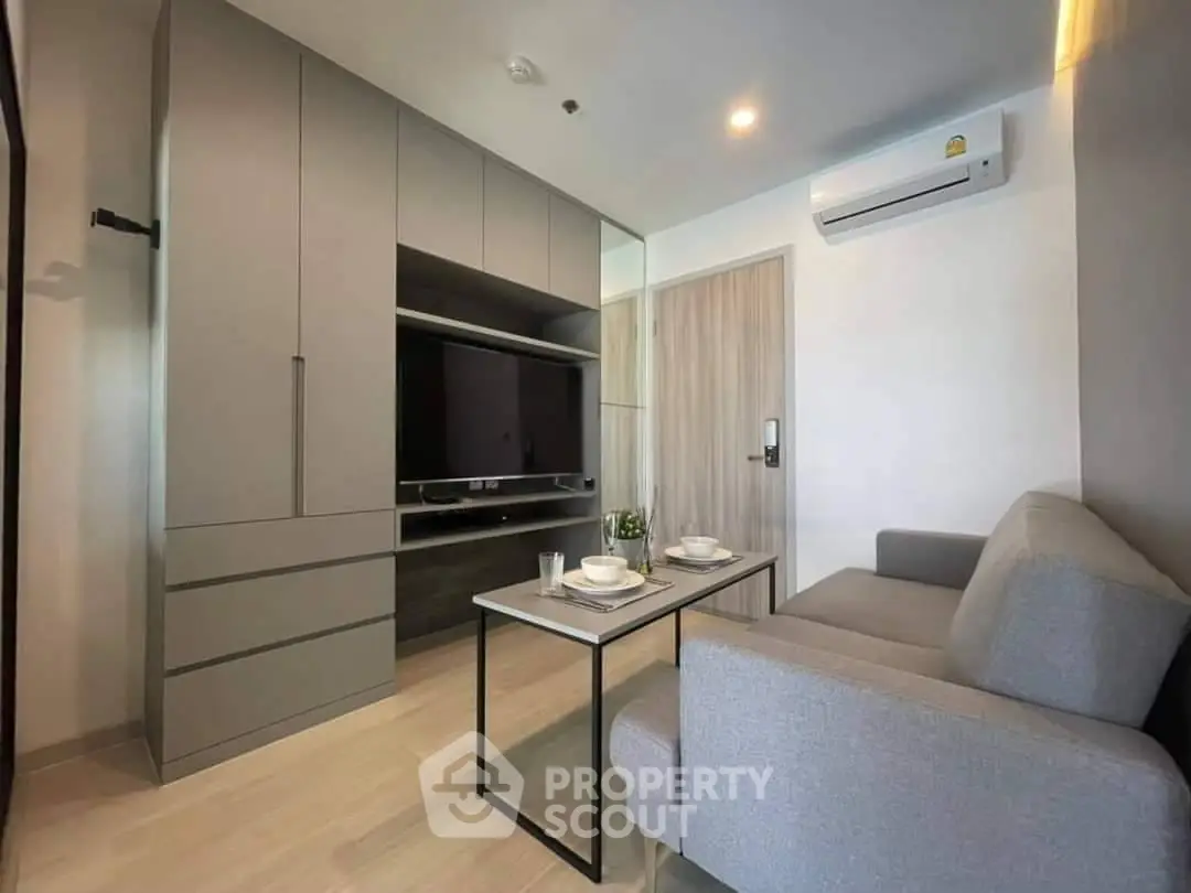 Modern living room with sleek furniture and built-in storage, perfect for urban living.