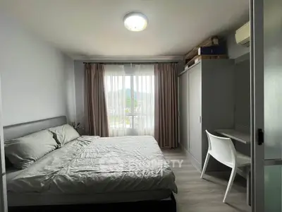 Modern bedroom with mountain view, featuring a cozy bed, sleek wardrobe, and stylish desk.