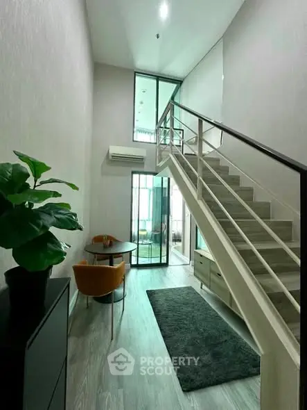 Modern duplex interior with stylish staircase and cozy seating area