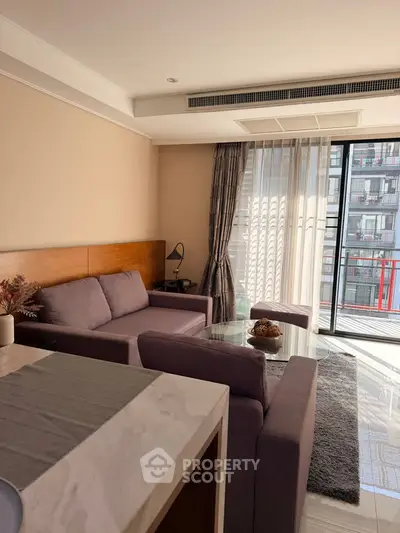 Modern living room with stylish furniture and large windows offering city views