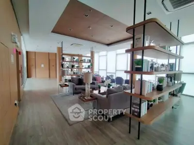 Spacious modern living room with stylish shelving and cozy seating area